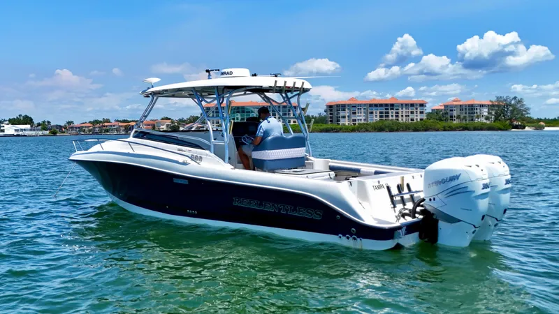 Slide: The Image of 2006 Hydra-Sports Vector VX boat cruising on a sunny day near coastal buildings. - 4