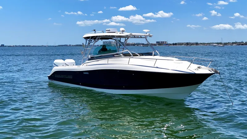 Slide: The Image of 2006 Hydra-Sports Vector VX boat on calm water under a clear blue sky. - 6