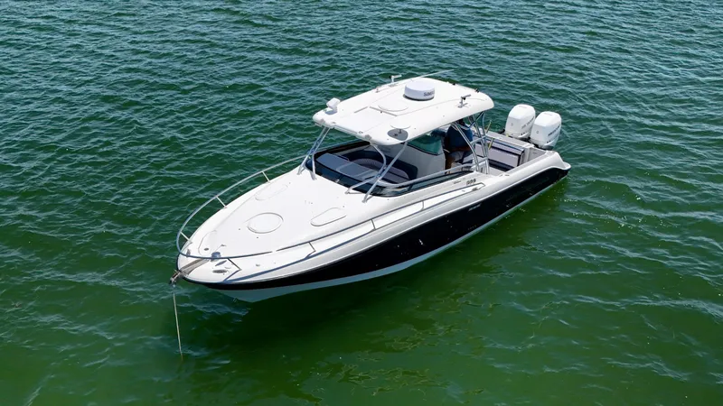 Slide: The Image of 2006 Hydra-Sports Vector VX boat on calm green water. - 9