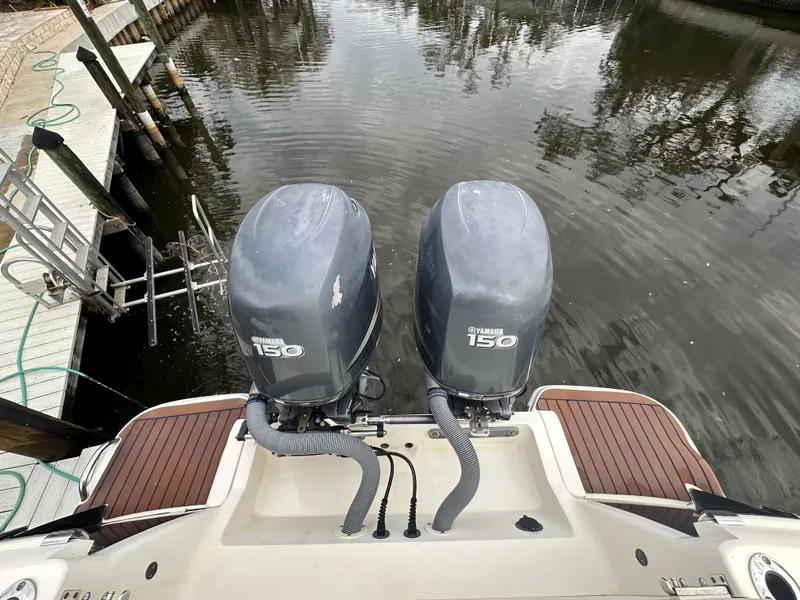 Slide: The Image of 2012 Scout 275 XSF boat with twin Yamaha 150 engines at dock. - 11