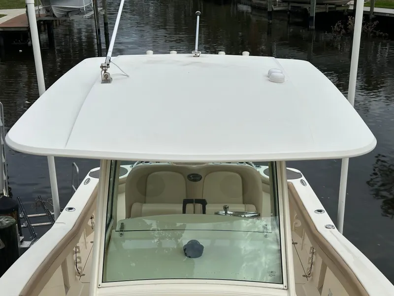 Slide: The Image of 2012 Scout 275 XSF boat with white hardtop on calm water. - 9