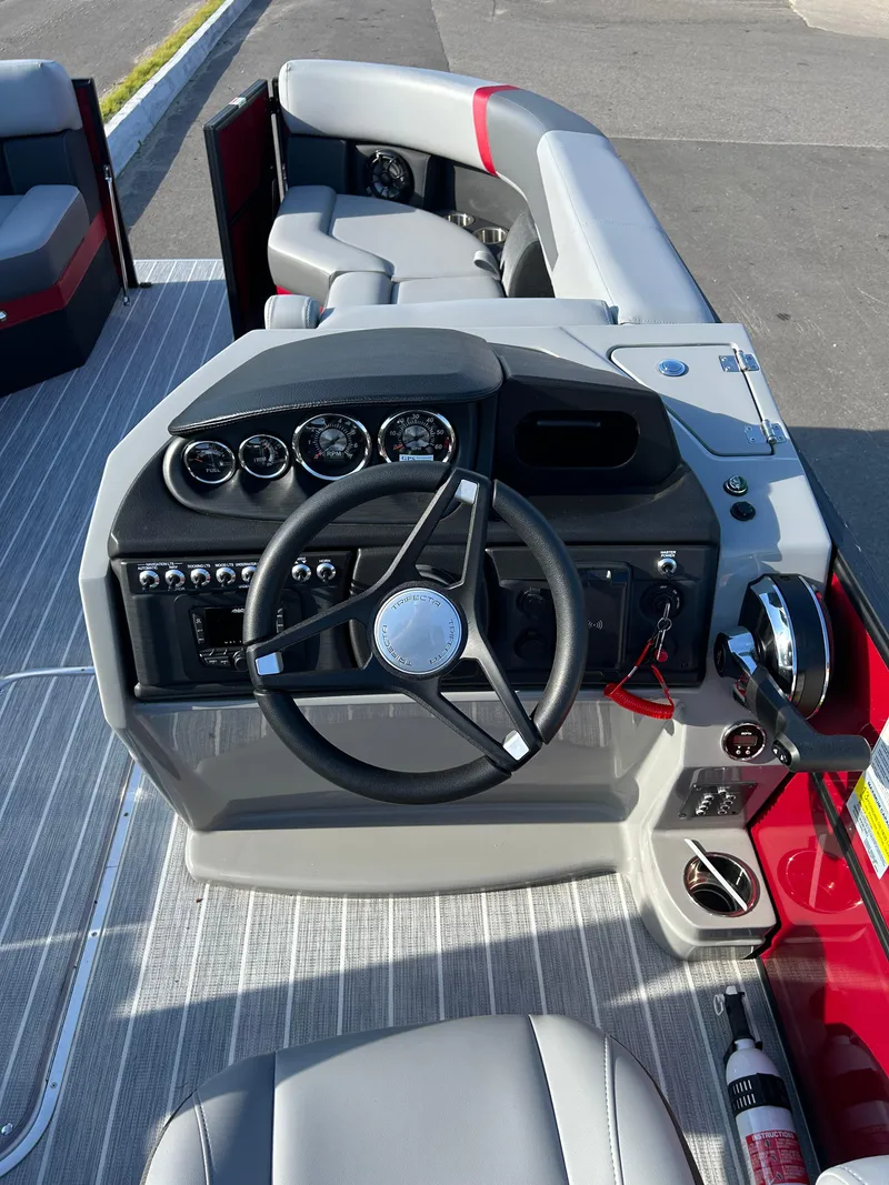 Slide: The Image of 2025 Trifecta 24ECS275 boat dashboard with steering wheel and control panel. - 6