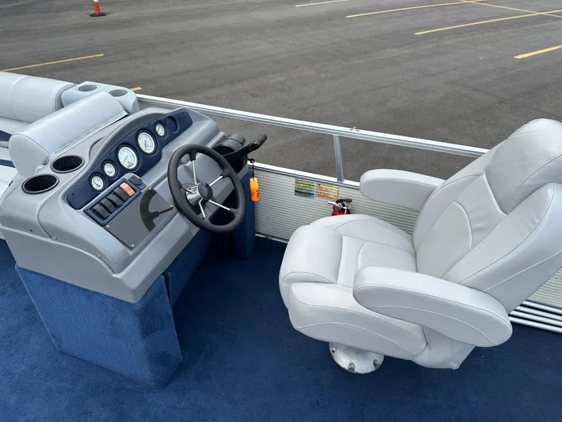 Slide: The Image of Captain's seat and helm of a 1997 Suncruiser 22 boat, featuring gauges and controls. - 10