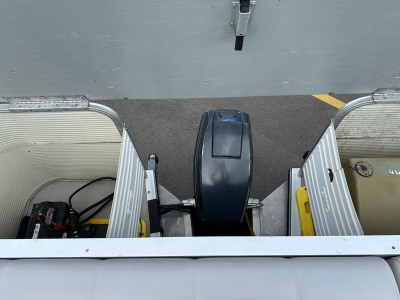 Slide: The Image of 1997 Suncruiser 22 boat engine compartment with battery and fuel tank. - 13