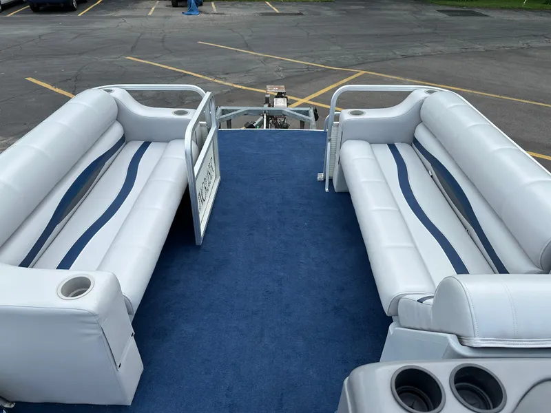 Slide: The Image of Interior of a 1997 Suncruiser 22 boat with white seating and blue carpet. - 7