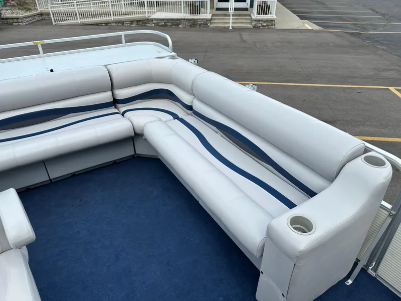 Slide: The Image of Interior of a 1997 Suncruiser 22 boat with white and blue seating. - 8