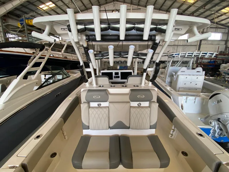 Slide: The Image of 2026 Key West 291 FS boat interior with seating and rod holders in a showroom. - 10