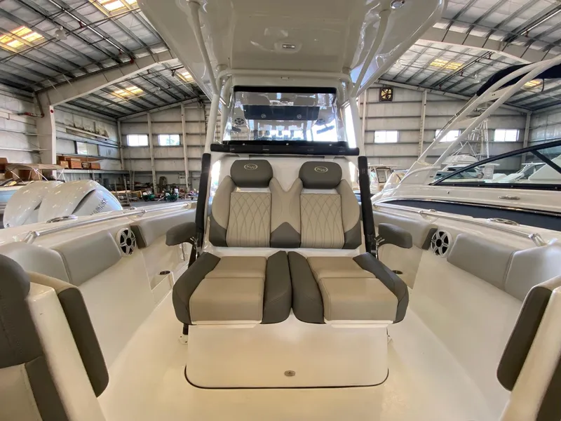 Slide: The Image of 2026 Key West 291 FS boat interior with cushioned seating in a spacious warehouse. - 12