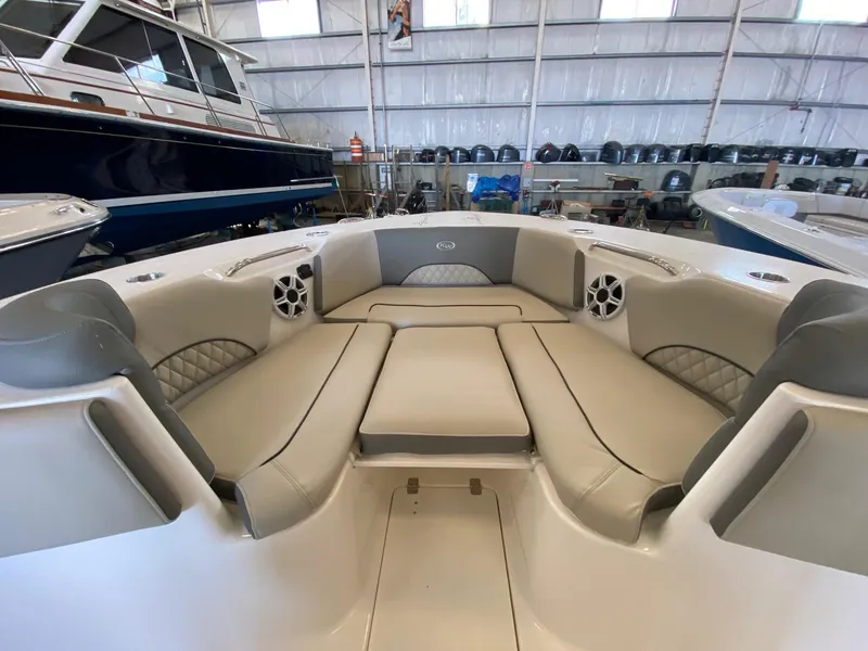 Slide: The Image of 2026 Key West 291 FS boat interior with cushioned seating in a showroom. - 16