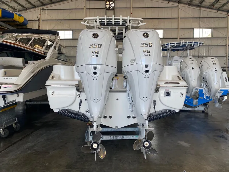 Slide: The Image of 2026 Key West 291 FS boat with twin 350 V6 engines in a storage facility. - 3