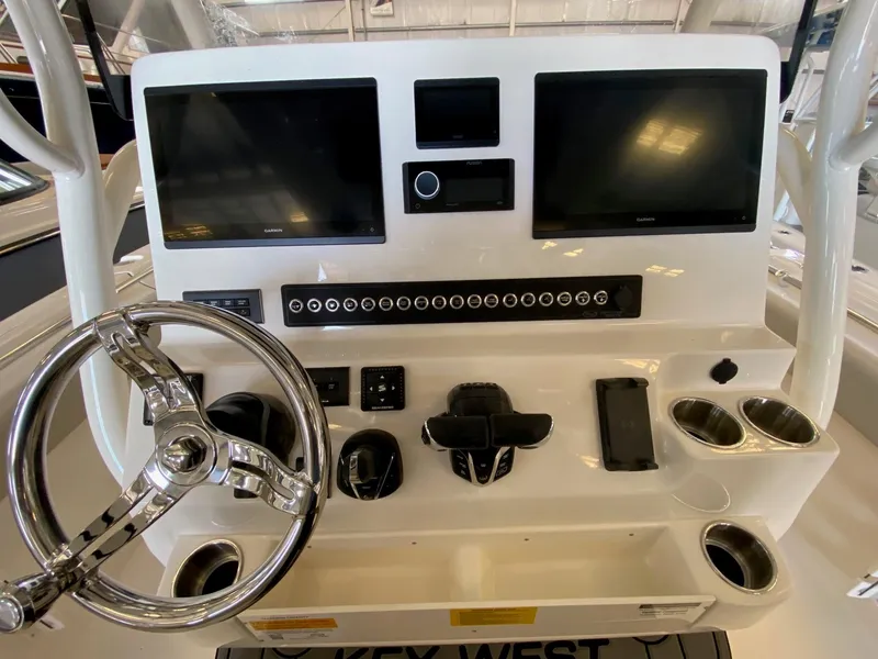 Slide: The Image of 2026 Key West 291 FS boat dashboard with dual screens and steering wheel. - 5