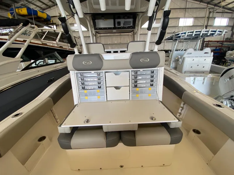 Slide: The Image of 2026 Key West 291 FS boat interior with storage compartments and seating in a showroom. - 9