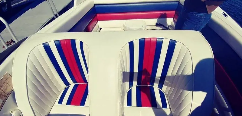 Slide: The Image of Interior of 1988 Fountain 12 Meter boat with striped seating in red, white, and blue. - 15