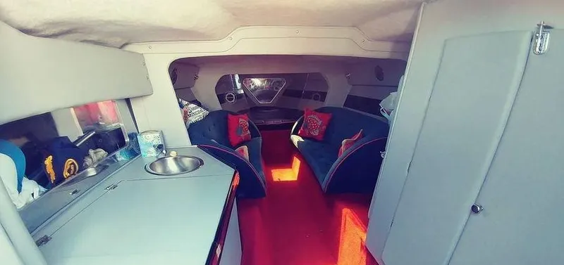 Slide: The Image of Interior of a 1988 Fountain 12 Meter boat with seating and kitchenette. - 18
