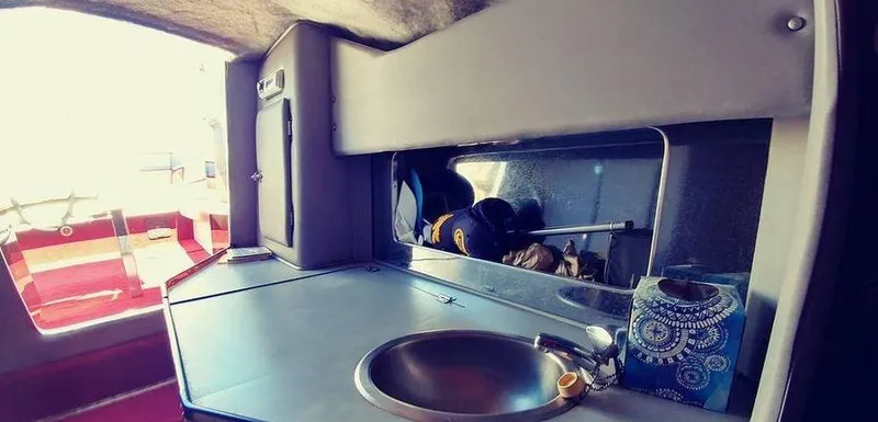 Slide: The Image of Interior of a 1988 Fountain 12 Meter boat with a compact kitchen area. - 19