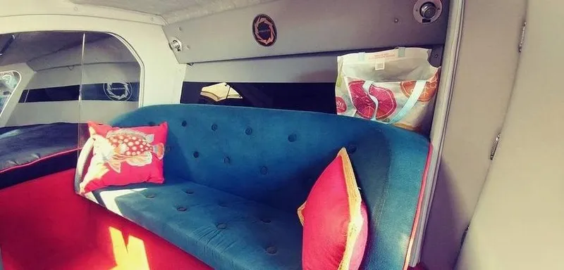 Slide: The Image of Interior of 1988 Fountain 12 Meter boat with blue sofa and colorful pillows. - 21