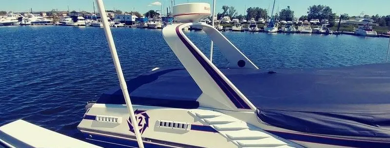 Slide: The Image of 1988 Fountain 12 Meter boat docked at a marina with other vessels. - 3