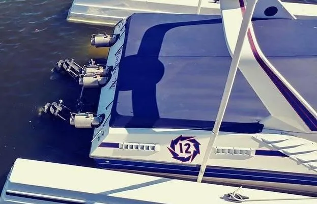 Slide: The Image of 1988 Fountain 12 Meter boat docked, featuring sleek design and powerful engines. - 4