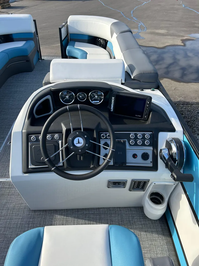 Slide: The Image of 2024 Trifecta 25C SS boat dashboard with steering wheel, controls, and seating. - 5
