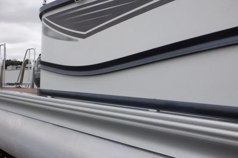 Slide: The Image of 2019 Premier 220 SunSation pontoon boat side view with sleek design details. - 12