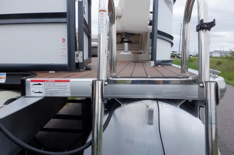 Slide: The Image of 2019 Premier 220 SunSation pontoon boat with stainless steel ladder and wooden deck. - 15