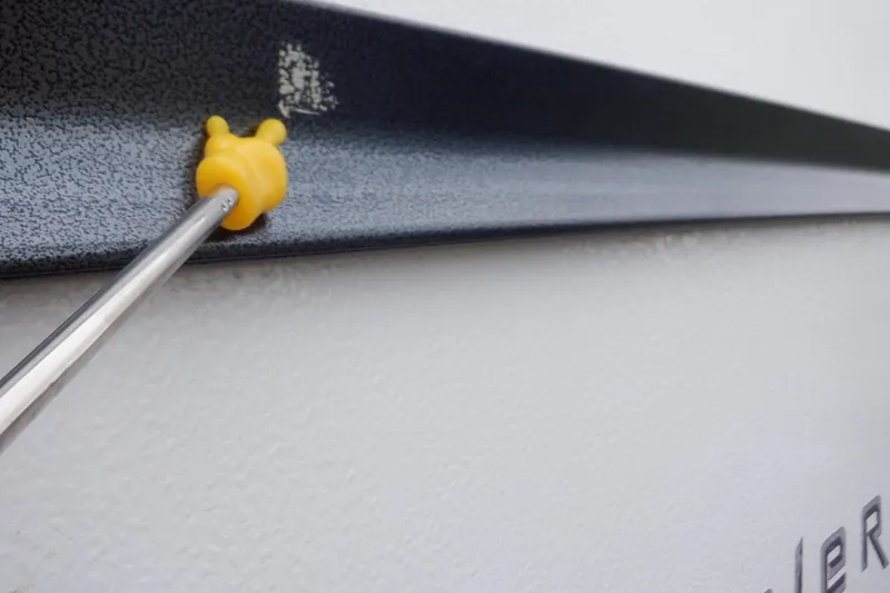 Slide: The Image of Close-up of a 2019 Premier 220 SunSation boat detail with yellow tool. - 17