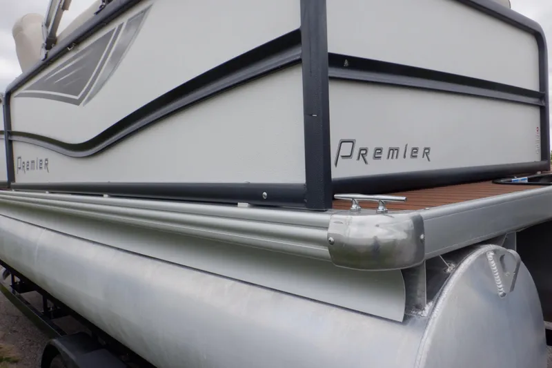 Slide: The Image of 2019 Premier 220 SunSation pontoon boat, side view, showcasing sleek design and branding. - 18