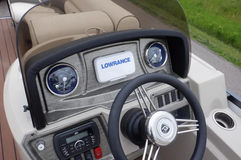 Slide: The Image of 2019 Premier 220 SunSation boat dashboard with Lowrance display and steering wheel. - 31