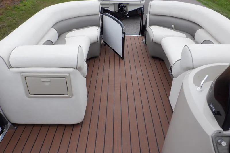 Slide: The Image of 2019 Premier 220 SunSation boat interior with plush seating and wood-style flooring. - 34