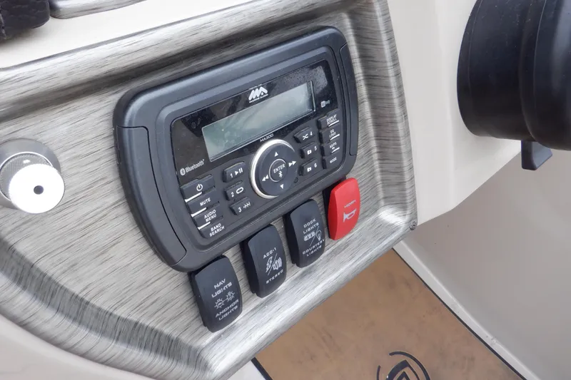 Slide: The Image of Control panel of 2019 Premier 220 SunSation boat with audio system and switches. - 35