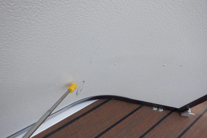 Slide: The Image of Yellow tool pointing at textured wall inside 2019 Premier 220 SunSation boat. - 36