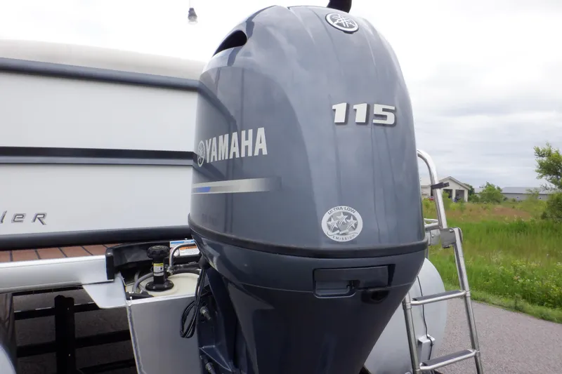 Slide: The Image of 2019 Premier 220 SunSation with Yamaha 115 outboard motor, parked outdoors. - 4