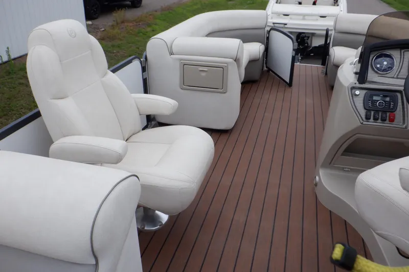 Slide: The Image of 2019 Premier 220 SunSation boat interior with plush seating and wood-style flooring. - 40