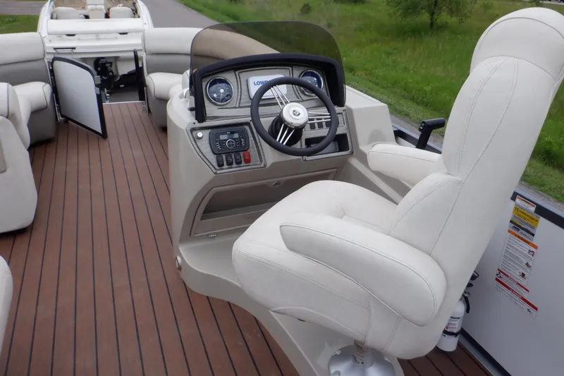 Slide: The Image of 2019 Premier 220 SunSation boat interior with captain's chair and control panel. - 41