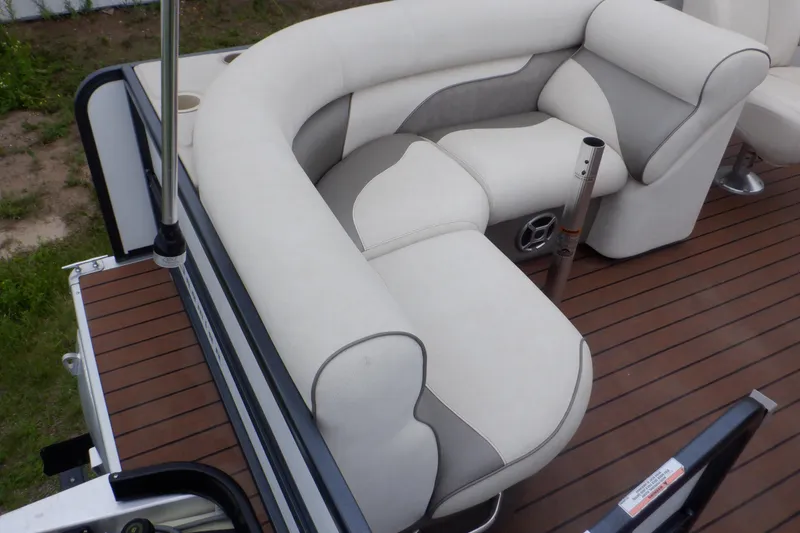 Slide: The Image of 2019 Premier 220 SunSation boat interior with white cushioned seating and wood-style flooring. - 42