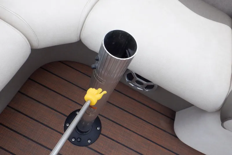 Slide: The Image of 2019 Premier 220 SunSation boat interior with beige seating and a metal pole on wooden flooring. - 43