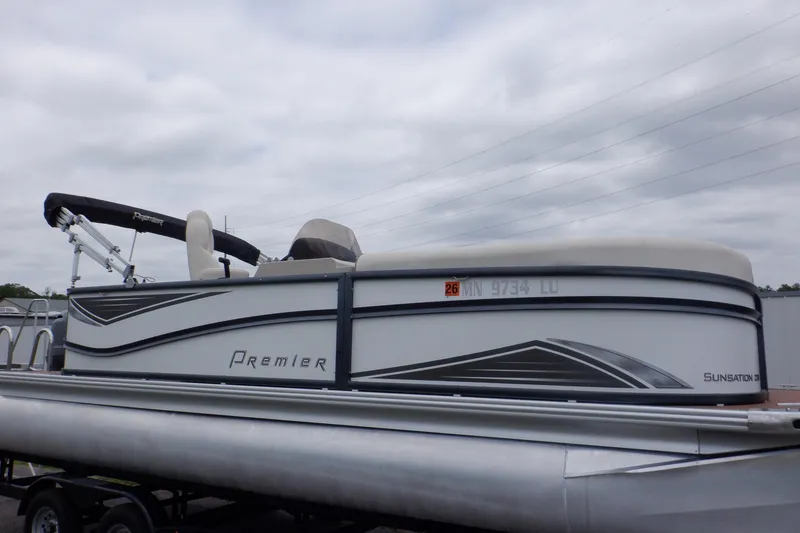 Slide: The Image of 2019 Premier 220 SunSation pontoon boat with sleek design on a trailer. - 47