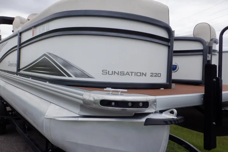 Slide: The Image of 2019 Premier 220 SunSation pontoon boat, side view, showcasing sleek design and branding. - 9