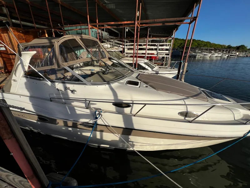 The Image of 1998 Regal Commodore 2760 boat docked at marina under blue sky. - 0