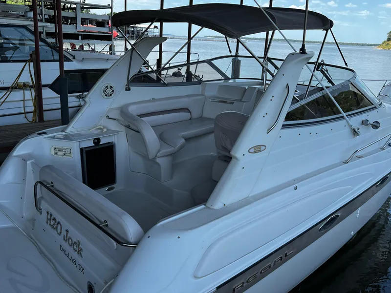 Slide: The Image of 1998 Regal Commodore 2760 boat docked, featuring spacious seating and canopy. - 10