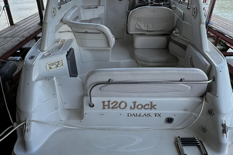 Slide: The Image of 1998 Regal Commodore 2760 boat interior with seating, labeled "H2O Jock," docked in Dallas, TX. - 13