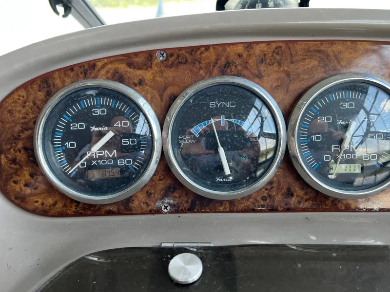 Slide: The Image of Dashboard gauges of a 1998 Regal Commodore 2760 boat, featuring RPM and sync meters. - 3