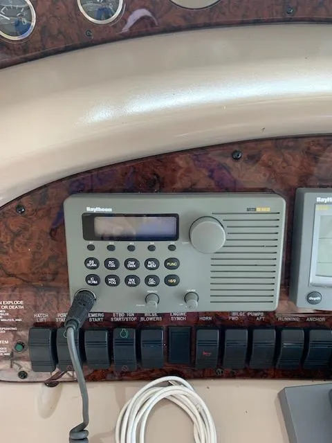 Slide: The Image of Control panel of a 2001 Sea Ray 380 Sundancer with Raytheon marine radio. - 19