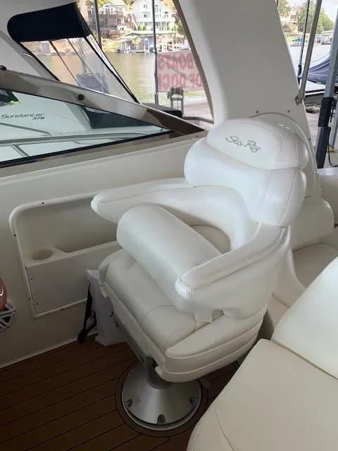 Slide: The Image of White captain's chair on 2001 Sea Ray 380 Sundancer yacht, docked with scenic background. - 20