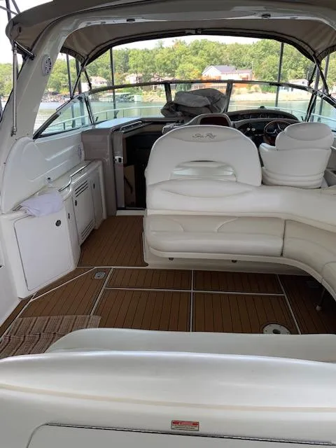 Slide: The Image of 2001 Sea Ray 380 Sundancer interior with white seating and wooden flooring. - 21
