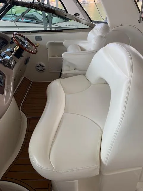 Slide: The Image of 2001 Sea Ray 380 Sundancer interior with white leather seating and wooden accents. - 22