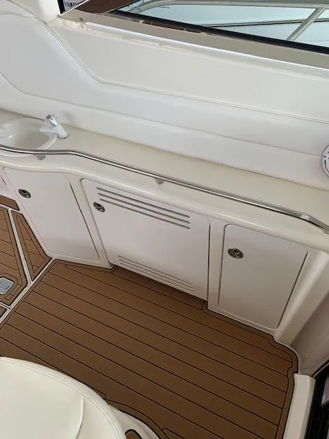 Slide: The Image of 2001 Sea Ray 380 Sundancer interior with sink and storage cabinets. - 23