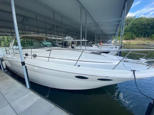 Slide: The Image of 2001 Sea Ray 380 Sundancer docked under a covered marina. - 3
