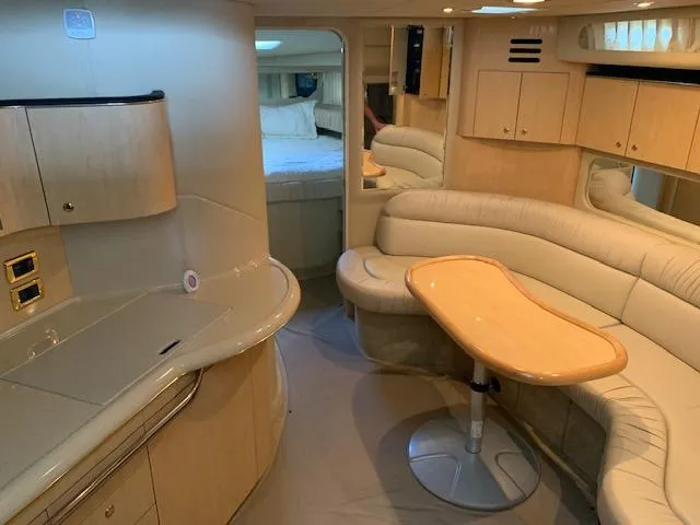 Slide: The Image of Luxurious interior of a 2001 Sea Ray 380 Sundancer yacht with elegant seating and cabinetry. - 36