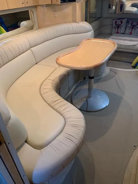 Slide: The Image of Interior of 2001 Sea Ray 380 Sundancer with curved seating and table. - 38